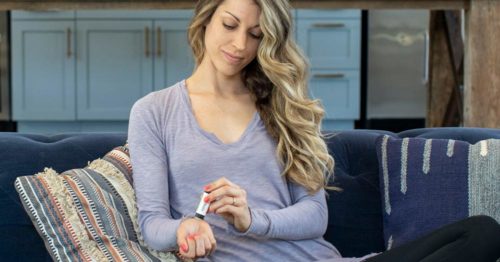 Girl Applying cbd balm to her wrist
